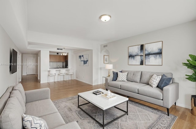 living room with light wood-type flooring and baseboards