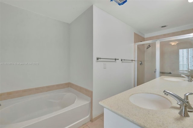 full bath with tile patterned flooring, a stall shower, a garden tub, and double vanity
