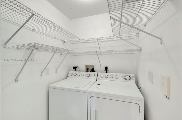 clothes washing area with separate washer and dryer