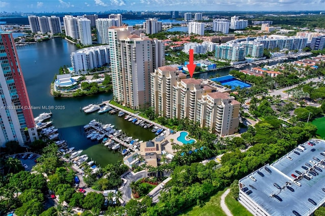 drone / aerial view featuring a view of city and a water view