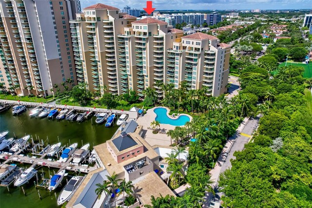 aerial overview of property's location with a nearby body of water, nearby urban area, and numerous boat docks