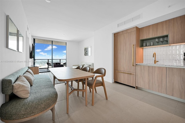 dining room featuring light tile patterned flooring and expansive windows