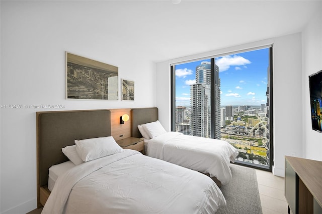 tiled bedroom with access to exterior and floor to ceiling windows