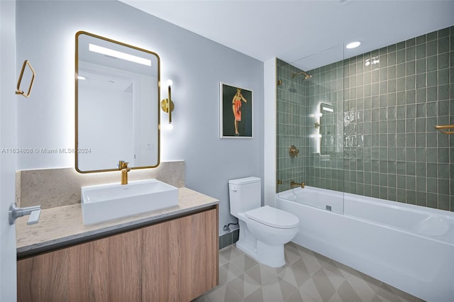 full bathroom with vanity, toilet, tiled shower / bath, and tile patterned flooring