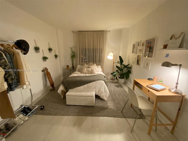 bedroom with hardwood / wood-style flooring