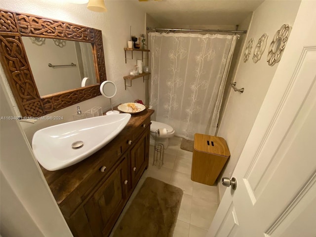 bathroom featuring vanity, tile patterned floors, and toilet