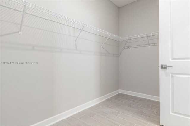 walk in closet featuring light hardwood / wood-style flooring