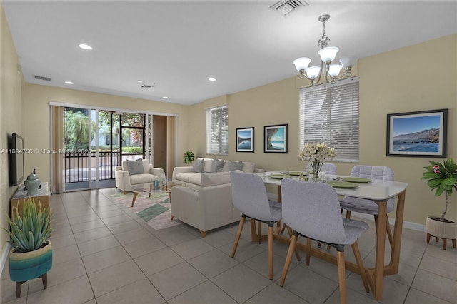 dining area with french doors, light tile patterned floors, and a chandelier