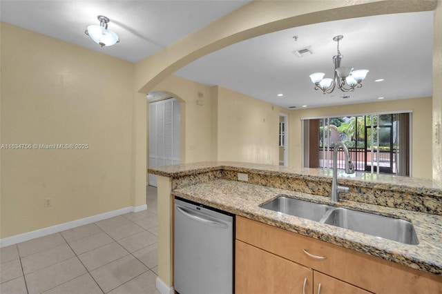 kitchen featuring a notable chandelier, dishwasher, light stone countertops, and sink