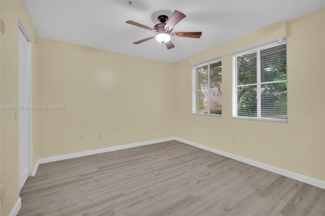 spare room with ceiling fan and light wood-type flooring