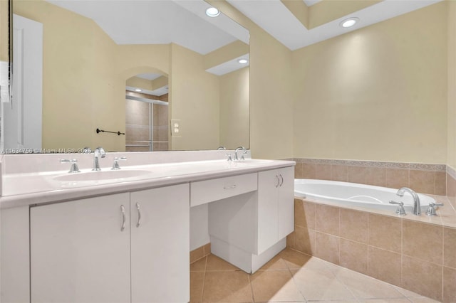 bathroom featuring tile patterned flooring, vanity, and separate shower and tub