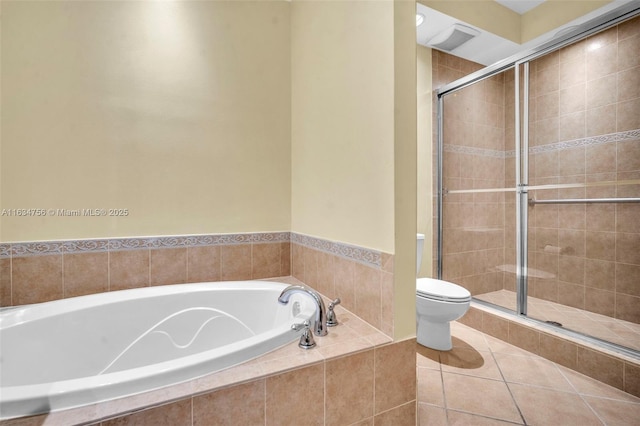 bathroom featuring tile patterned floors, toilet, and shower with separate bathtub