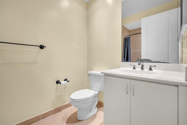 bathroom featuring toilet, a shower with curtain, vanity, and tile patterned floors