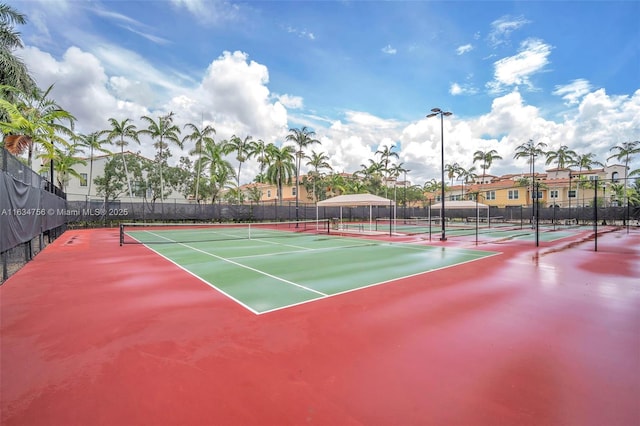 view of tennis court featuring basketball hoop