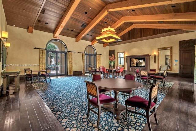 dining area featuring dark hardwood / wood-style flooring, french doors, and high vaulted ceiling