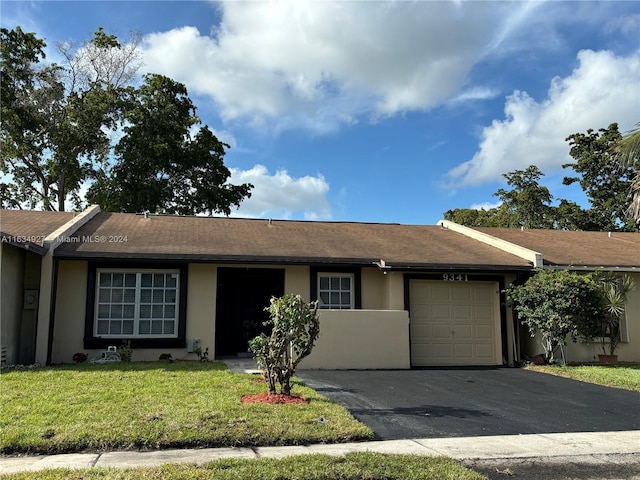 ranch-style home with a garage and a front yard