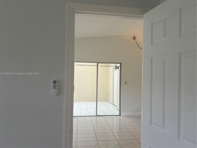 hall with light tile patterned floors