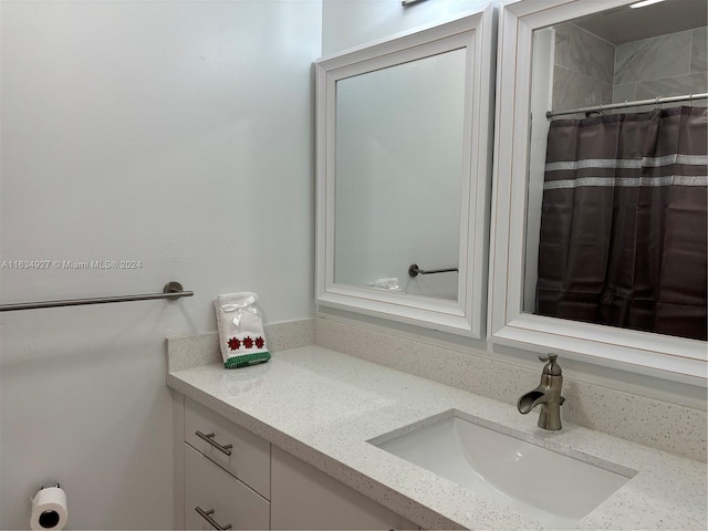 bathroom featuring vanity and a shower with shower curtain