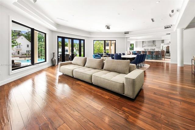 living room with ornamental molding, hardwood / wood-style floors, and french doors