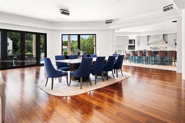 dining area with french doors, hardwood / wood-style flooring, and ornamental molding