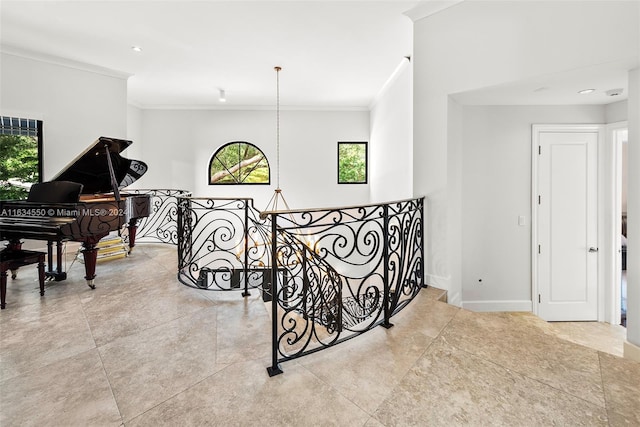 corridor with ornamental molding, a wealth of natural light, an upstairs landing, and tile patterned flooring