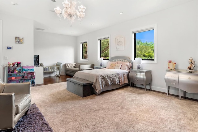bedroom with carpet flooring, multiple windows, a chandelier, and baseboards