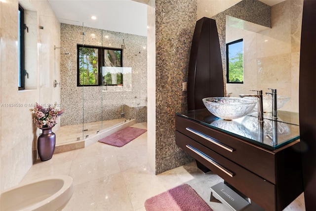 bathroom with vanity, a bidet, tile patterned floors, tile walls, and a shower with door