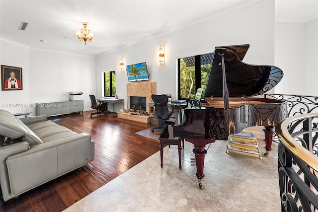 living room featuring an inviting chandelier, crown molding, hardwood / wood-style floors, and a wealth of natural light