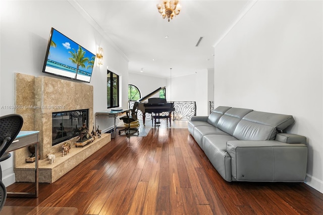 living room with crown molding, dark wood-type flooring, and a high end fireplace