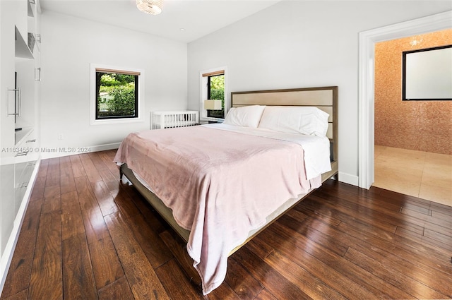 bedroom with dark wood-type flooring