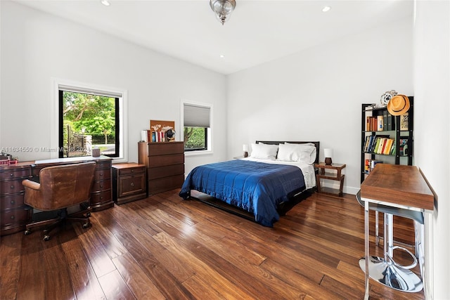 bedroom with recessed lighting and dark wood finished floors