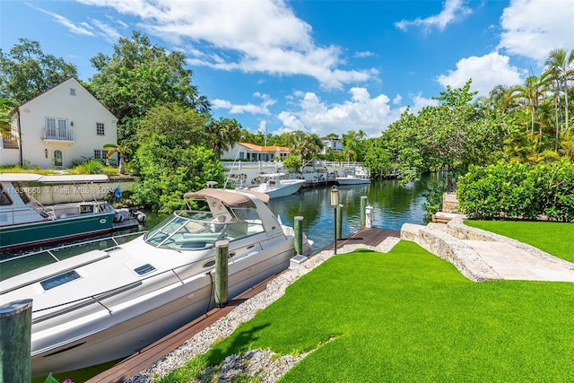 dock area featuring a water view and a lawn