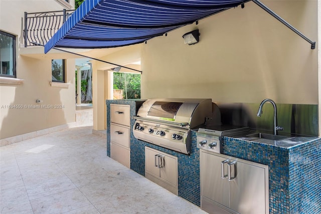 view of patio featuring grilling area, sink, and an outdoor kitchen