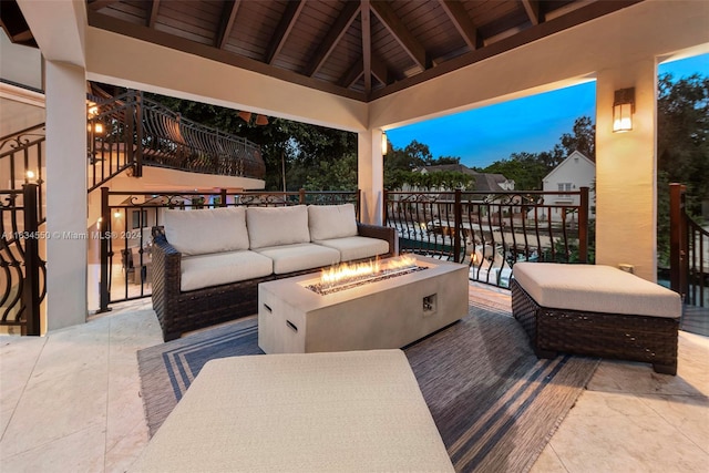 patio terrace at dusk with a gazebo and an outdoor living space with a fire pit