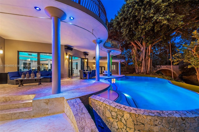 view of swimming pool featuring a patio and a jacuzzi