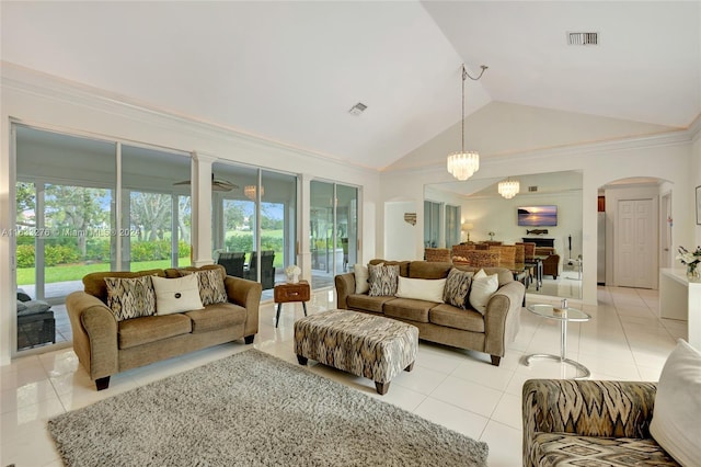 living room with light tile patterned floors, plenty of natural light, visible vents, and arched walkways