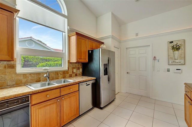 kitchen featuring light tile patterned flooring, sink, decorative backsplash, and stainless steel appliances