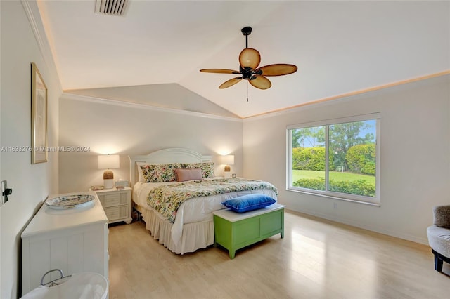 bedroom featuring visible vents, light wood-style flooring, ornamental molding, vaulted ceiling, and baseboards