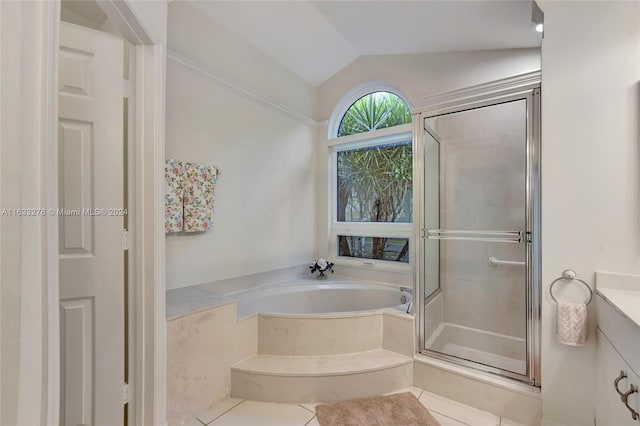 bathroom with tile patterned flooring, lofted ceiling, independent shower and bath, and vanity