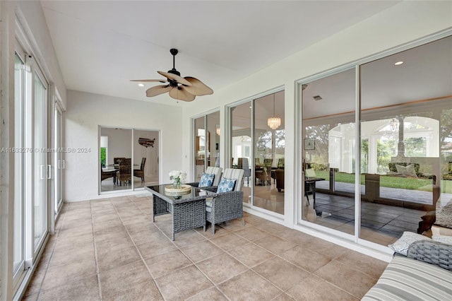 sunroom / solarium with a ceiling fan