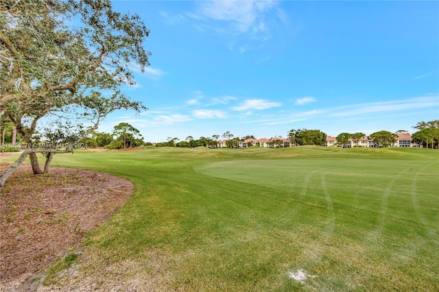 view of home's community with a yard and golf course view