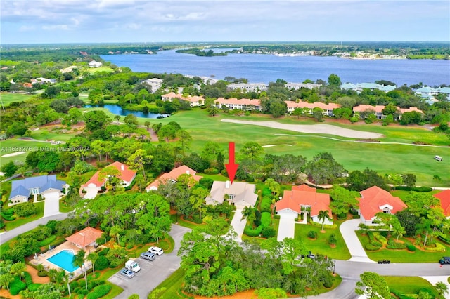 aerial view featuring a residential view, view of golf course, and a water view