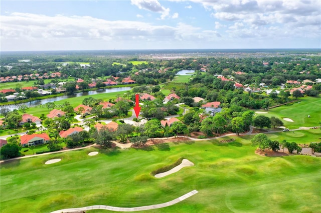 drone / aerial view with view of golf course and a water view