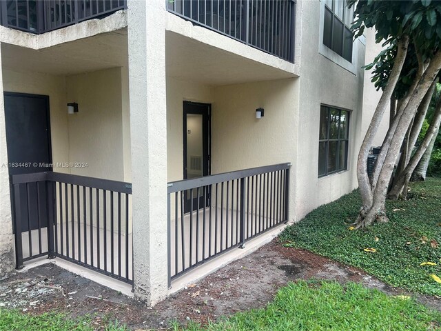 entrance to property with a balcony