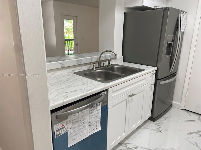 kitchen featuring light tile patterned flooring, white cabinetry, sink, light stone counters, and appliances with stainless steel finishes