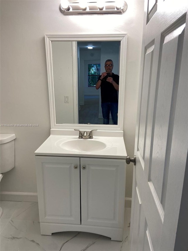 bathroom with vanity, toilet, and tile patterned floors