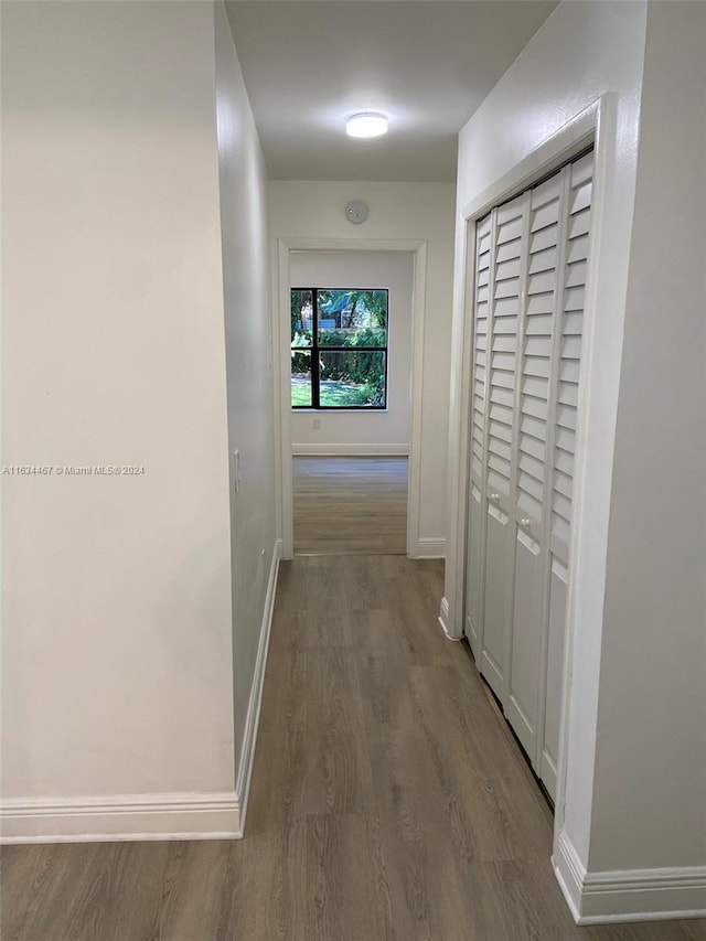 corridor with hardwood / wood-style flooring