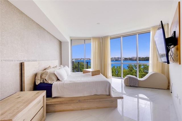 bedroom featuring floor to ceiling windows and light tile patterned floors