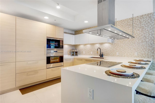 17111 Biscayne Blvd Unit 304, North Miami Beach, FL 33160 - kitchen featuring island range hood, black appliances, modern cabinets, light countertops, and light brown cabinets
