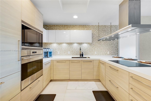 17111 Biscayne Blvd Unit 304, North Miami Beach, FL 33160 - kitchen with light brown cabinets, wall chimney exhaust hood, stainless steel oven, built in microwave, and modern cabinets